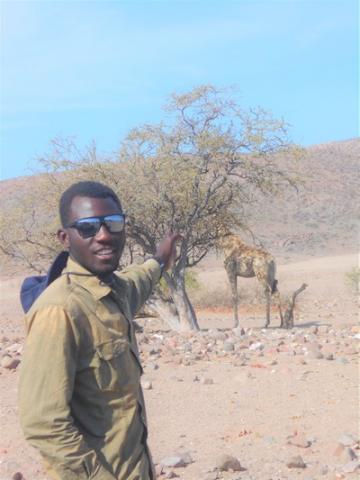 Jackson Hamutenya with a giraffee in NW Namibia